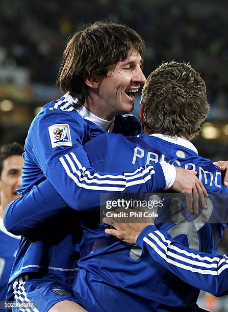 Martin Palermo of Argentina celebrates scoring the second goal with team mate Lionel Messi during the 2010 FIFA World Cup South Africa Group B match...