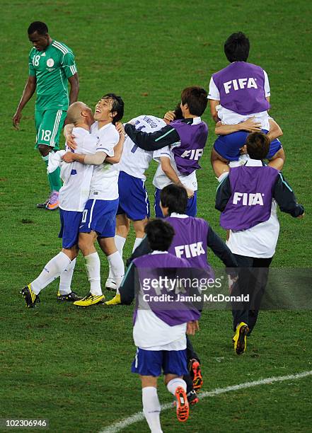 The South Korea team celebrates after a draw gives them victory and progress to round two in the 2010 FIFA World Cup South Africa Group B match...