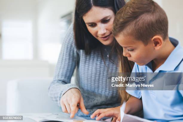 boy getting tutored with school assignment - coach stock pictures, royalty-free photos & images