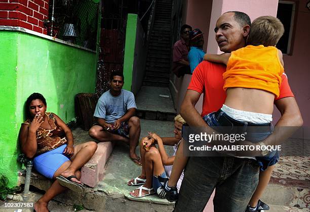 Cuban dissident Darsi Ferrer , holds a child in front of his house in Santo Suarez neighborhood, Havana, on June 22 after he was released from jail...