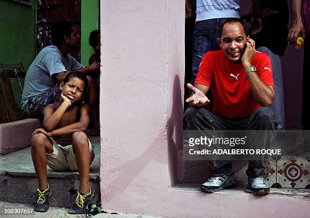 Cuban dissident Darsi Ferrer , speaks on a mobile phone at his house in Santo Suarez neighborhood, Havana, on June 22 after he was released from jail...