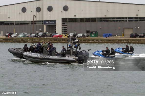 Police officers in inflatable boats patrol the western entrance to ...