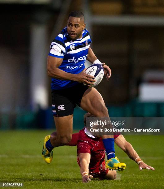 Bath Rugby's Joe Cokanasiga evades the tackle of Scarlets' Leigh Halfpenny during the Premiership Rugby Pre-Season Friendly match between Bath and...