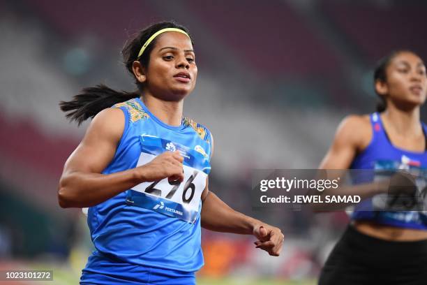 India's Dutee Chand competes in a heat of the women's 100m athletics event during the 2018 Asian Games in Jakarta on August 25, 2018.