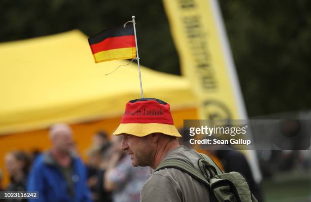 Man wearing a hat in the colors of the German flag attends a gathering hosted by the Identitarian Movement on August 25, 2018 in Dresden, Germany....