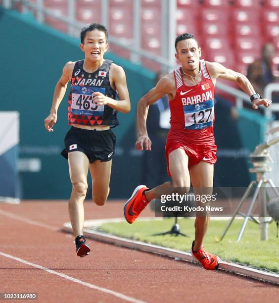 Japan's Hiroto Inoue competes against Bahrain's Elhassan Elabbassi en route to winning in the men's marathon at the Asian Games in Jakarta on Aug....