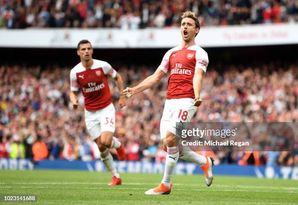 Nacho Monreal of Arsenal celebrates after scoring his team's first goal during the Premier League match between Arsenal FC and West Ham United at...