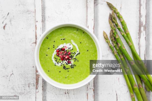 green asparagus soup with pomegranate seeds and black sesame - soup stock pictures, royalty-free photos & images