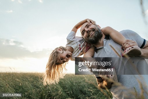 Mature man playing with his little daughter in nature Mature man playing with his little daughter in nature