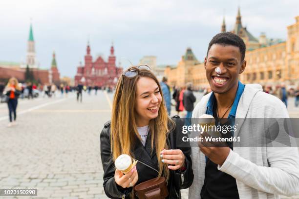 russia, moscow, couple eating icecream in the city - russia travel stock pictures, royalty-free photos & images