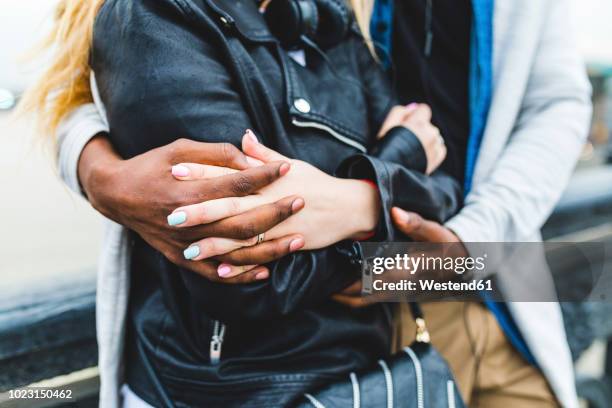 russia, moscow, multiracial couple, embracing and holding hands - black and white holding hands stock-fotos und bilder