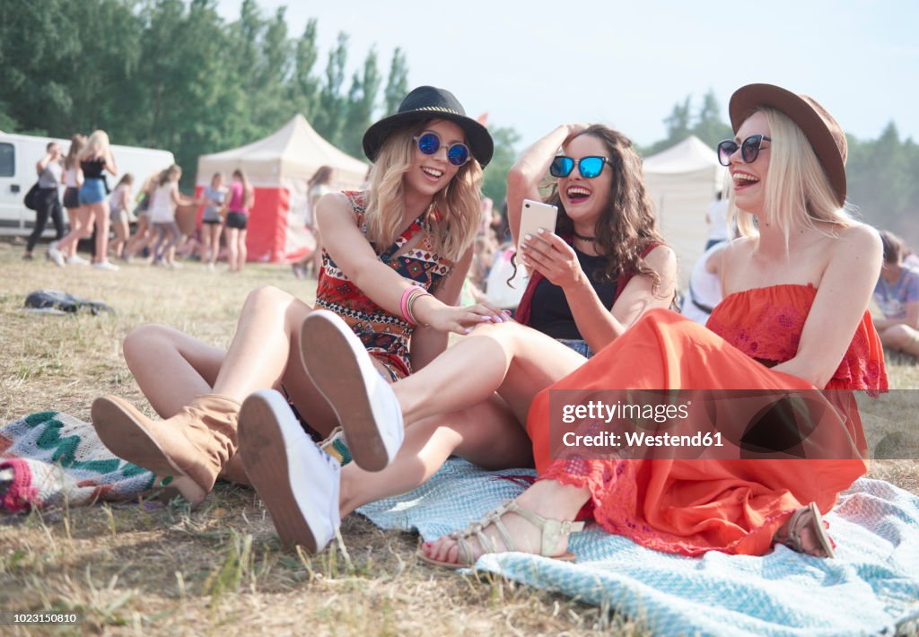 Happy friends making selfie at music festival