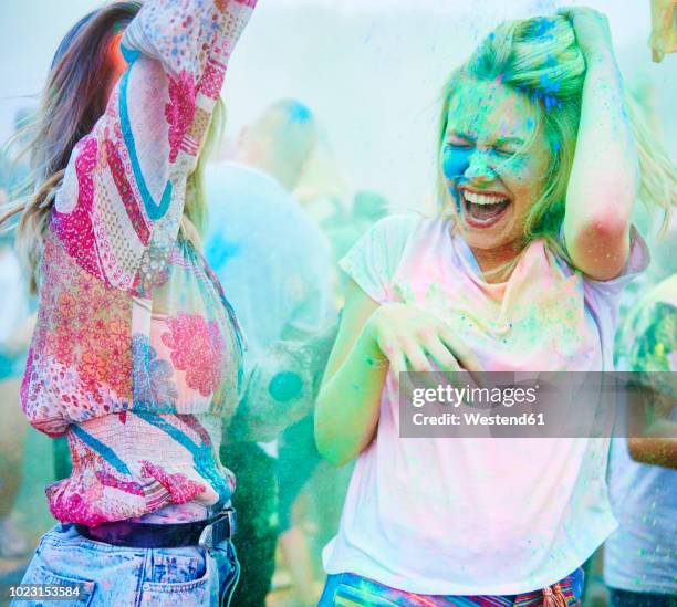 friends dancing at music festival, holi powder - woman holi stock pictures, royalty-free photos & images