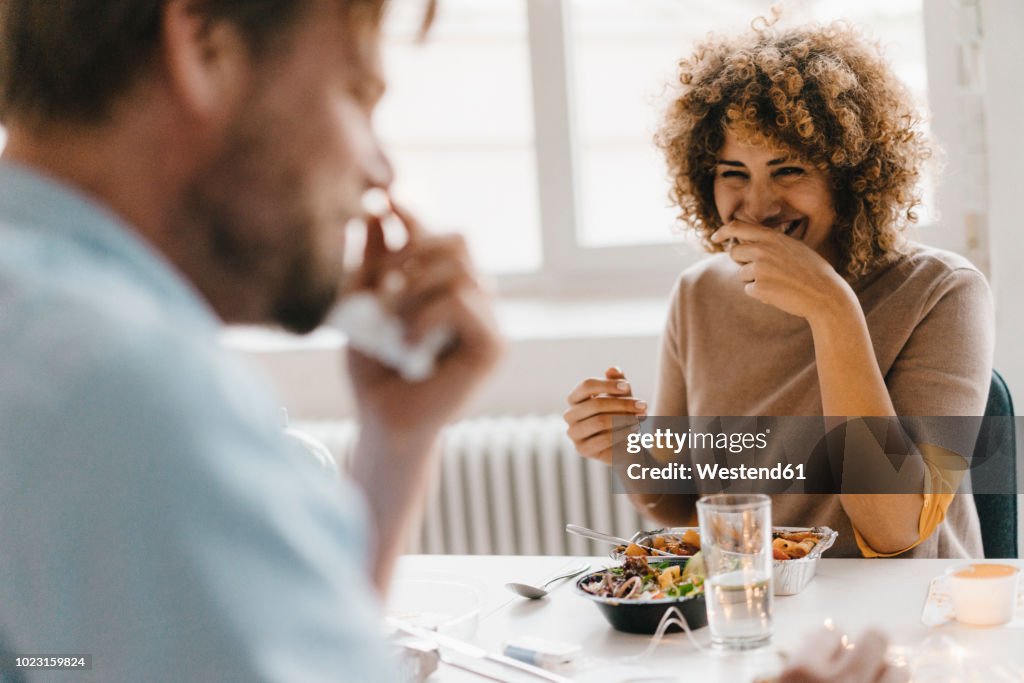 Colleagues joking at lunch break, eating healthy food