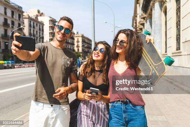 three happy friends taking a selfie in the city - esp 14 24 photos et images de collection