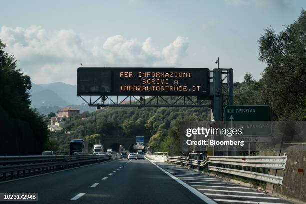 Signage indicates the direction to Genoa on the A12 Highway operated by Autostrade per l'Italia SpA, near Genoa, Italy, on Friday, Aug. 24, 2018....