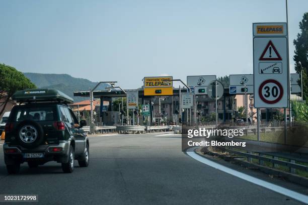Sport utility vehicle approaches a toll booth on the A12 Highway operated by Autostrade per l'Italia SpA. Near Genoa, Italy, on Friday, Aug. 24,...