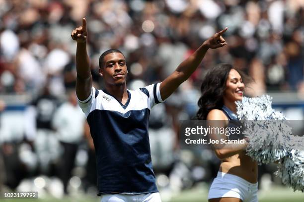 Quinton Peron performs with the Los Angeles Rams cheerleaders during the game between the Los Angeles Rams and the Oakland Raiders at Los Angeles...
