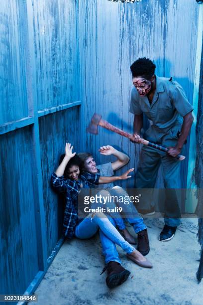 zombie in haunted house standing over victims with axe - axe murderer stock pictures, royalty-free photos & images