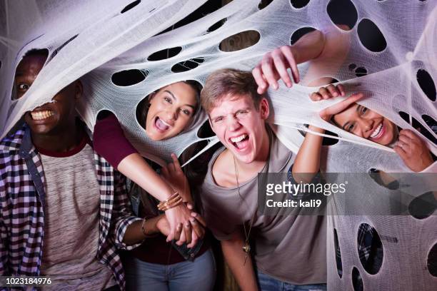 multi-etnische groep van jonge volwassenen in de spookhuis - caught in the act stockfoto's en -beelden