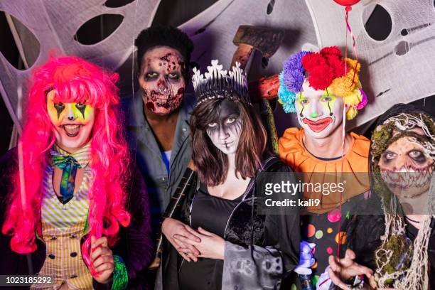 zombies, ghouls and a clown in halloween haunted house - stage costume stock pictures, royalty-free photos & images
