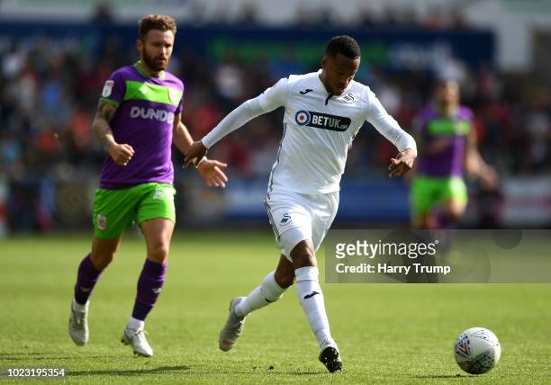 Martin Olsson of Swansea City looks to break past Matty Taylor of Bristol City during the Sky Bet Championship match between Swansea City and Bristol...