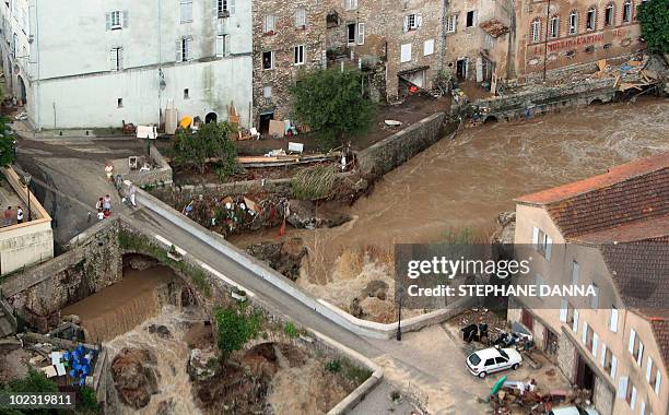 An aerial picture shows a bridge over the overflowed Nartuby river in the French southeastern city of Trans-en-Provence, on June 17, 2010 in the...