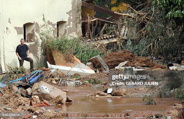 People check the damages in the aftermath of flooding in a western district of the French south eastern city of Les Arcs sur Argens on June 16, 2010....