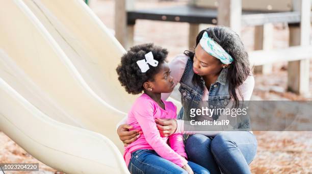 mother helping sad little girl on playground - female disciplinarians stock pictures, royalty-free photos & images
