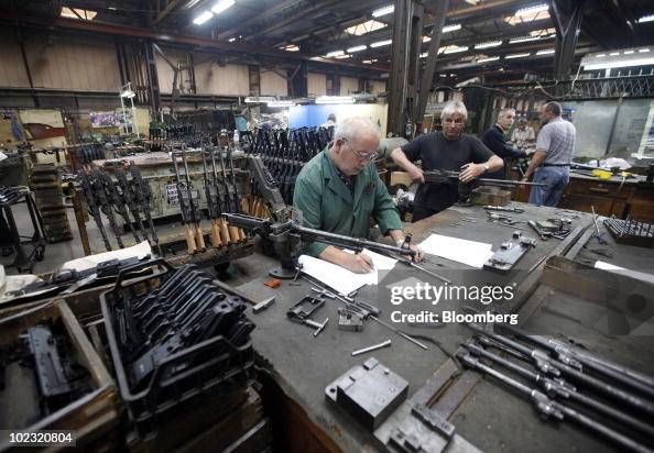 Employees work on the assembly of the M84 machine gun at the Zastava ...