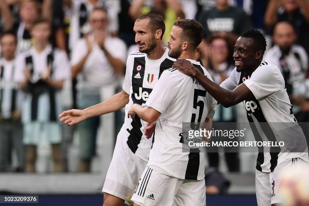Juventus' Italian defender Giorgio Chiellini, Juventus' Bosnian midfielder Miralem Pjanic and Juventus' French midfielder Blaise Matuidi celebrate...