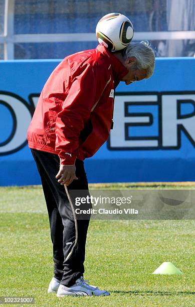 Italy Head Coach Marcello Lippi balances a ball on his neck during an Italy training session at the 2010 FIFA World Cup on June 23, 2010 in...