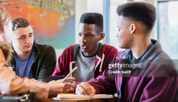 multi-ethnic teenage friends studying together - serious teenager boy stock pictures, royalty-free photos & images