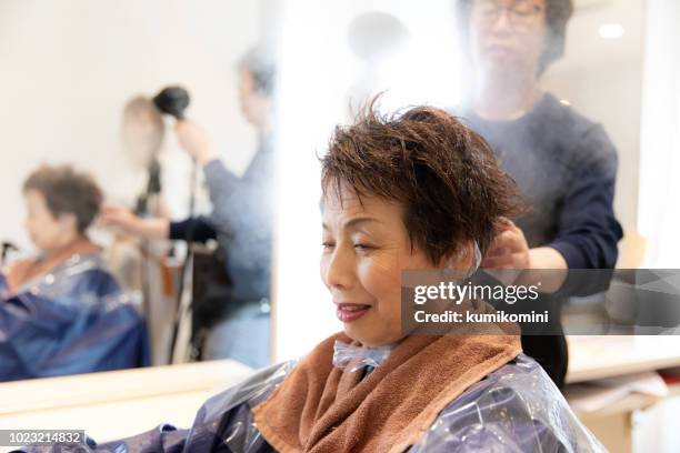 japanese senior woman having beauty treatment - mirror steam stock pictures, royalty-free photos & images