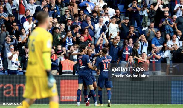 Kylian Mbappe of Paris Saint-Germain celebrates his goal with Edinson Cavani and Neymar Jr during the Ligue 1 match between Paris Saint-Germain and...