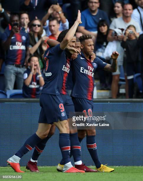 Kylian Mbappe of Paris Saint-Germain celebrates his goal with Edinson Cavani and Neymar Jr during the Ligue 1 match between Paris Saint-Germain and...