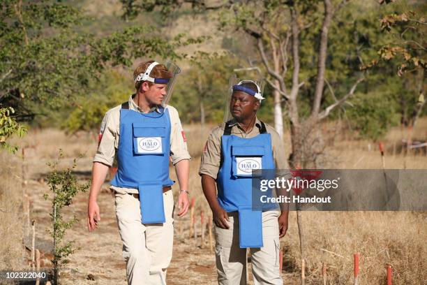 In this handout image provided by The HALO Trust, Prince Harry is seen with a deminer from The HALO Trust, a British charity dedicated to removal of...