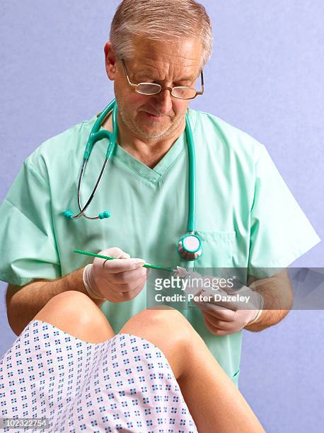gynecologist taking smear test - virus del papilloma umano foto e immagini stock