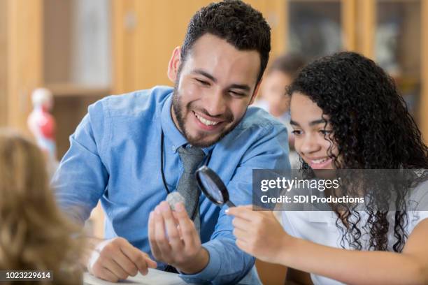 science teacher shows student interesting specimen - geology class stock pictures, royalty-free photos & images