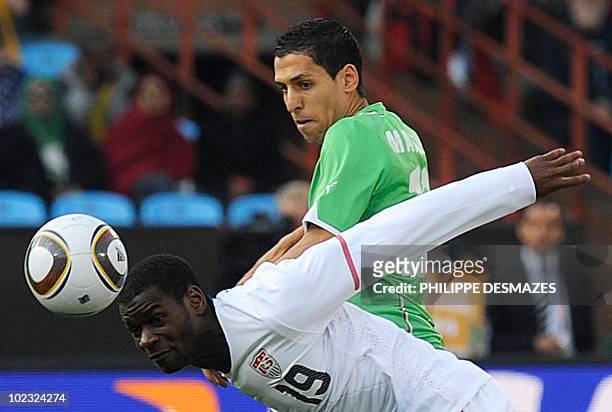 Midfielder Maurice Edu fights for the ball with Algeria's midfielder Karim Matmour during their Group C first round 2010 World Cup football match on...