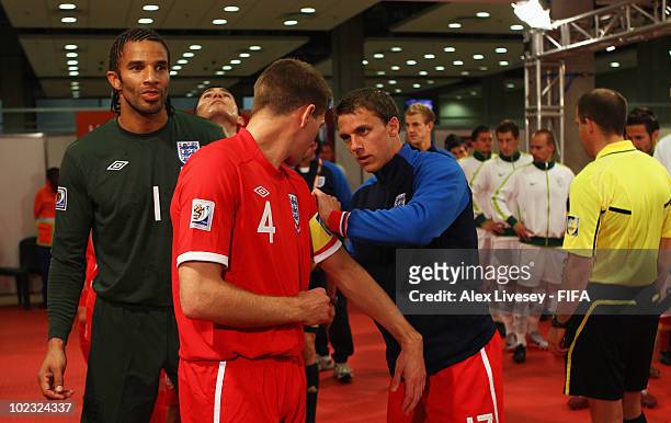 Steven Gerrard of England has his captains armband adjusted by Stephen Warnock of England during the 2010 FIFA World Cup South Africa Group C match...