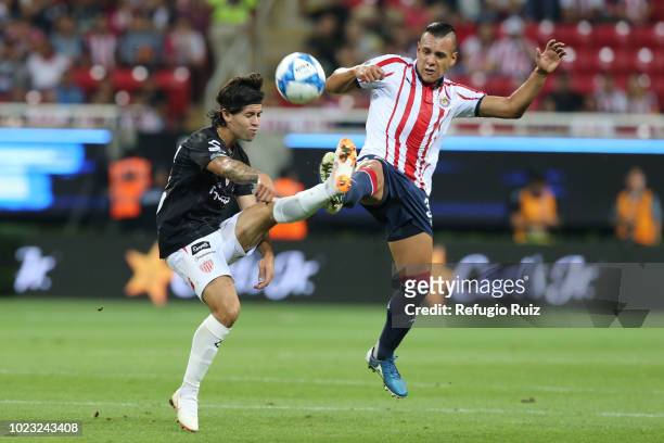 Mario de Luna of Chivas fights for the ball with Víctor Dávila of Necaxa during the 6th round match between Chivas and Necaxa as part of the Torneo...