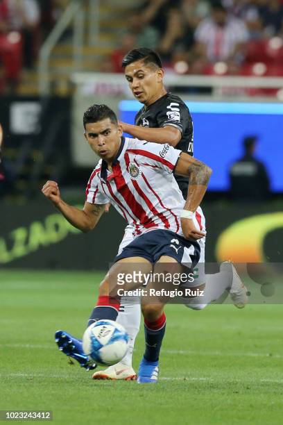 Orbelin Pineda of Chivas fights for the ball with Dieter Villalpando of Necaxa during the 6th round match between Chivas and Necaxa as part of the...
