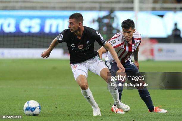 Michael Perez of Chivas fights for the ball with Facundo Castro of Necaxa during the 6th round match between Chivas and Necaxa as part of the Torneo...