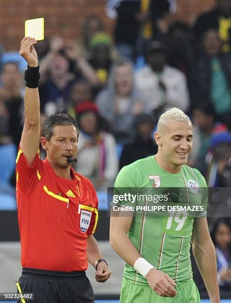 Algeria's midfielder Hassan Yebda gets a yellow card from Referee Frank de Bleeckere during the Group C, first round, 2010 World Cup football match...