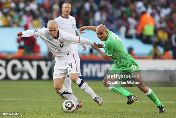 Michael Bradley of the United States and Rafik Djebbour of Algeria tussle for the ball during the 2010 FIFA World Cup South Africa Group C match...