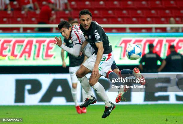 Leobardo Lopez of Necaxa fights for the ball with Angel Zaldivar of Chivas during the 6th round match between Chivas and Necaxa as part of the Torneo...