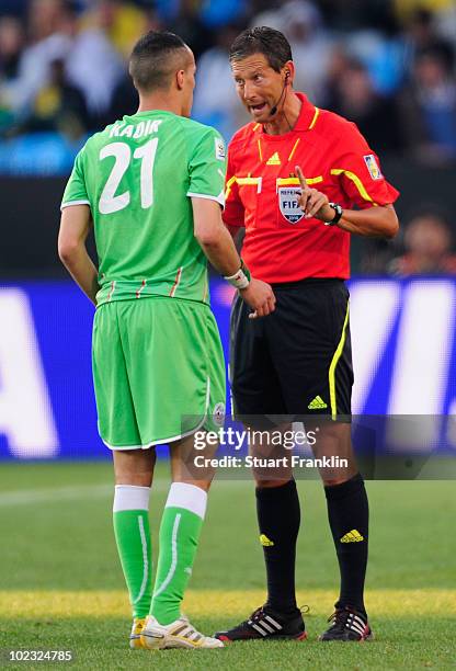 Referee Frank de Bleeckere speaks to Foued Kadir of Algeria during the 2010 FIFA World Cup South Africa Group C match between USA and Algeria at the...