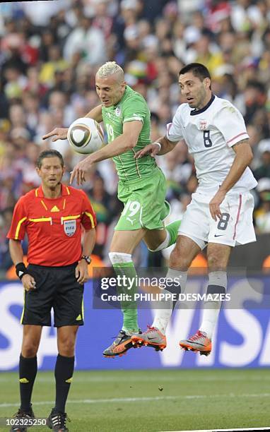 Algeria's midfielder Hassan Yebda fights for the ball with US midfielder Clint Dempsey as Belgian referee Frank De Bleeckere looks on during their...