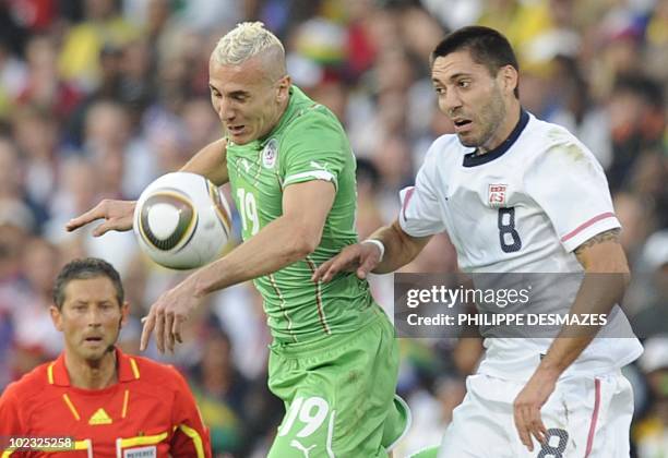 Algeria's midfielder Hassan Yebda fights for the ball with US midfielder Clint Dempsey as Belgian referee Frank De Bleeckere looks on during their...